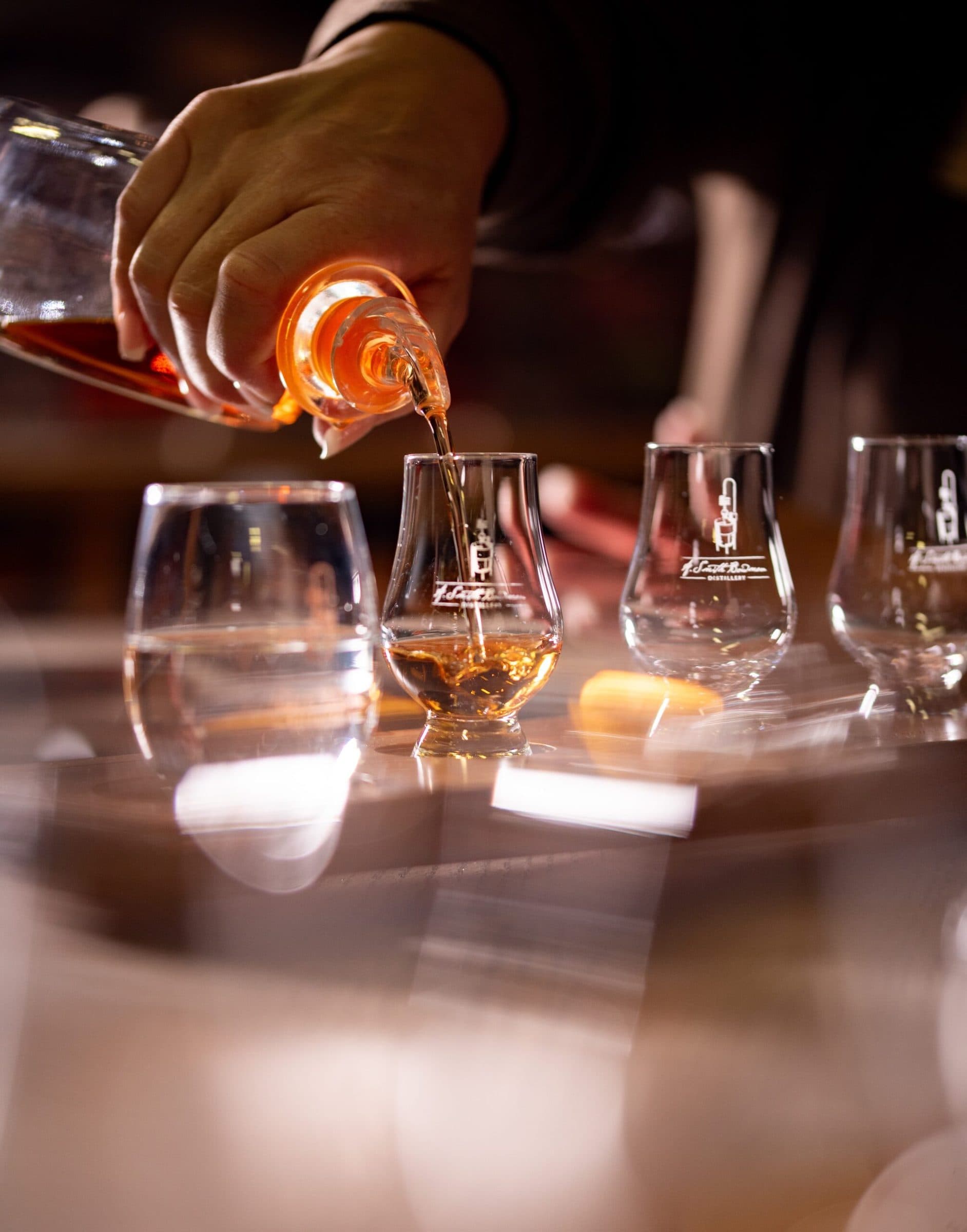 Bourbon poured into tasting glasses at A. Smith Bowman Distillery